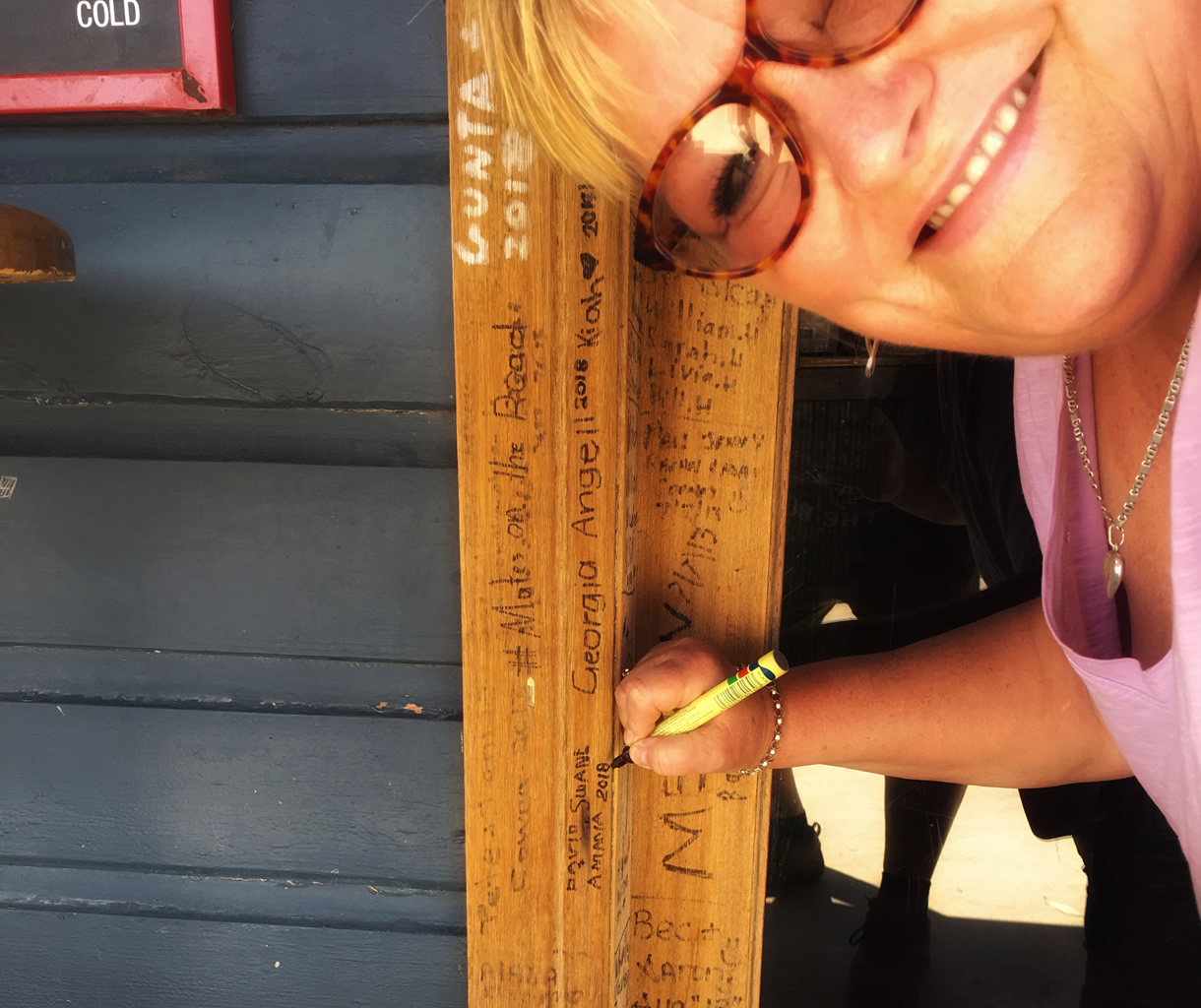 Signing The Door Frame At The Tilpa Hotel