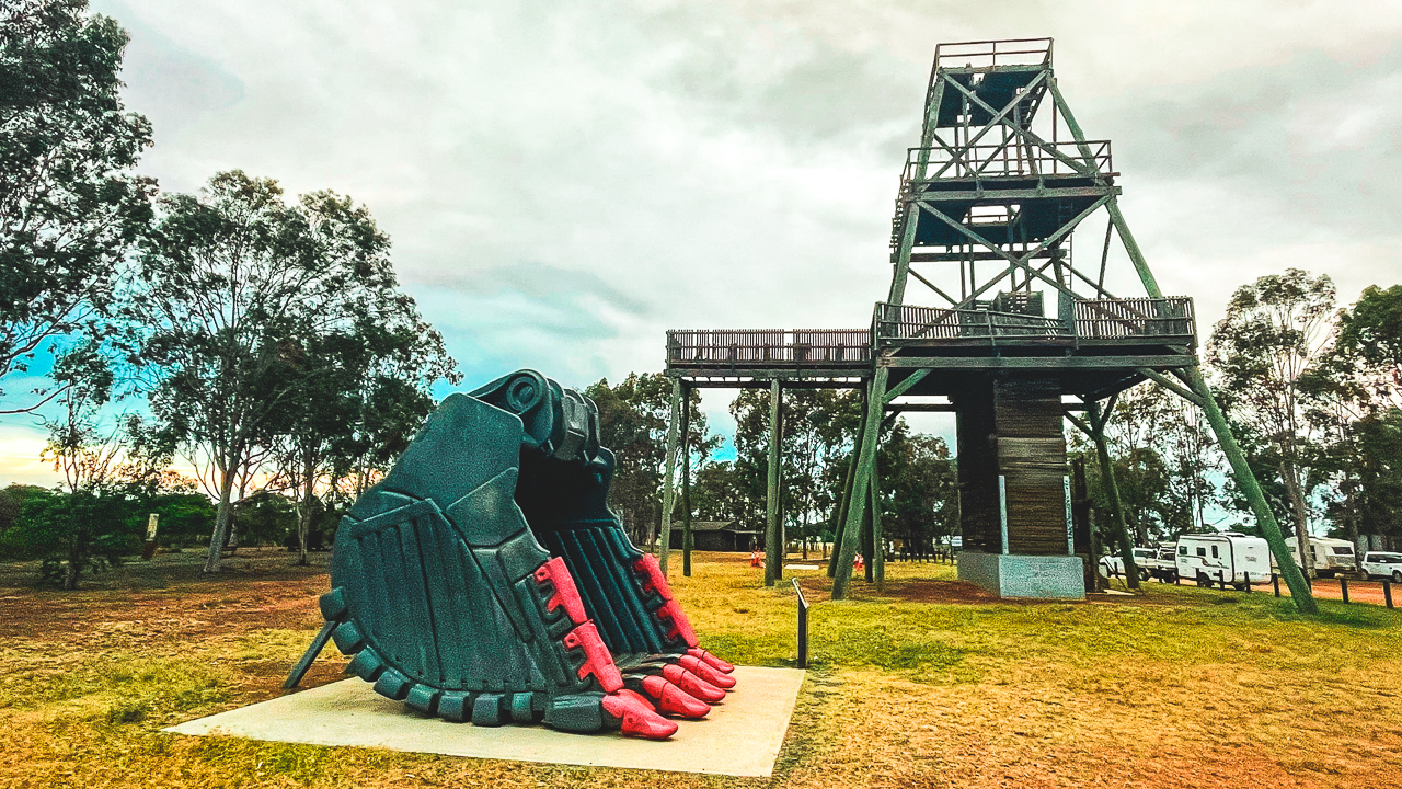 Digger Bucket In Front Of Poppet Head At Cooinda Park Wyalong